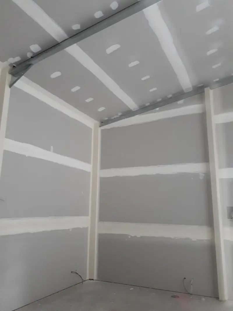 Plastering contractors applying set coat in a retail fitout in Seymour VIC