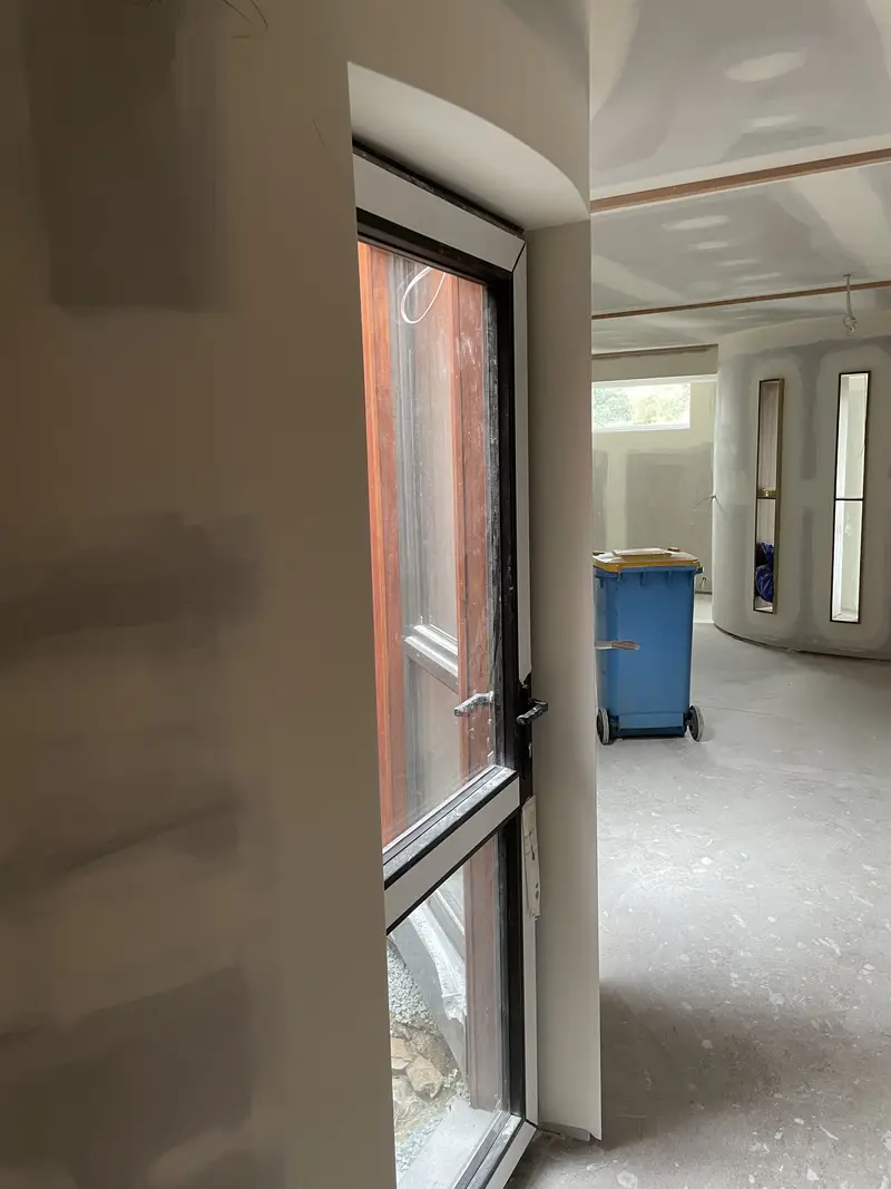 Plasterer installing cornice as part of domestic plastering job in Seymour